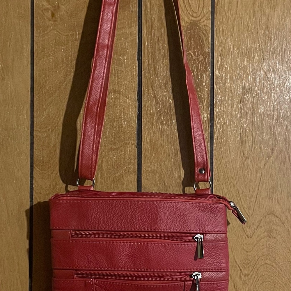 Cute red crossbody bag with an adjustable strap.